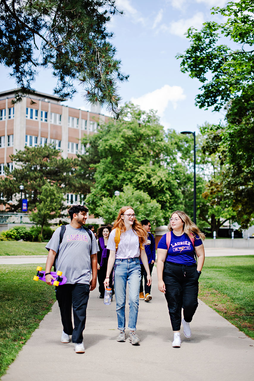 Students walking in front of Laurier Library in Summer