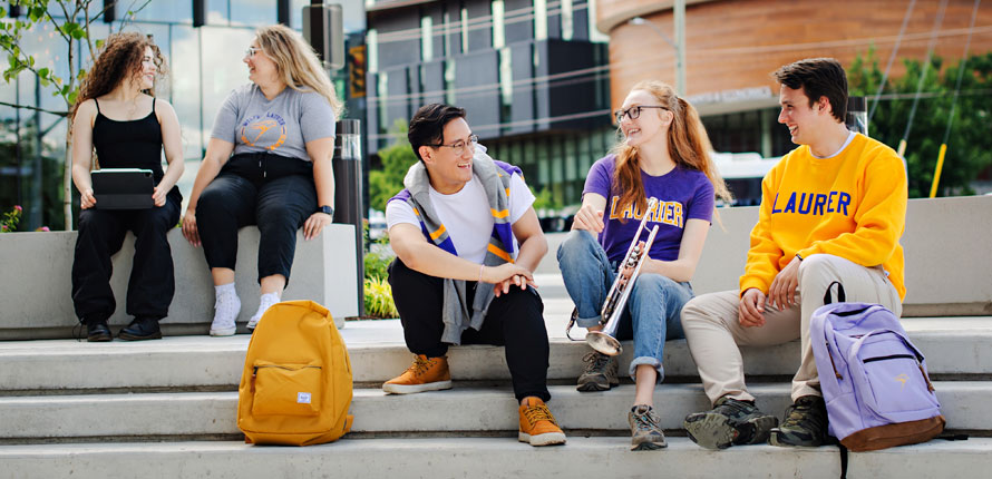 Students sitting outside Music Building