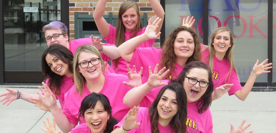 care group posing in pink shirts