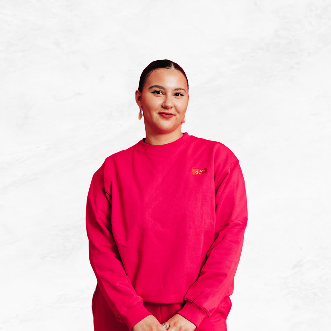 Woman smiling in front of a white background