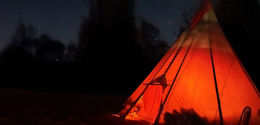 Teepee at night against a starry sky