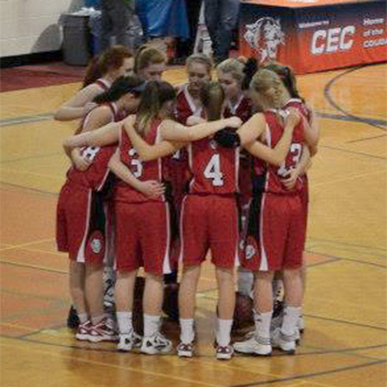 Girls basketball team huddling