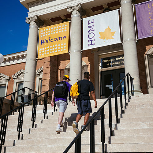 students walking up Carnegie Building steps