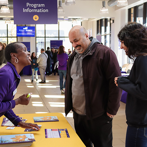 Parent and student speaking to Laurier staff.