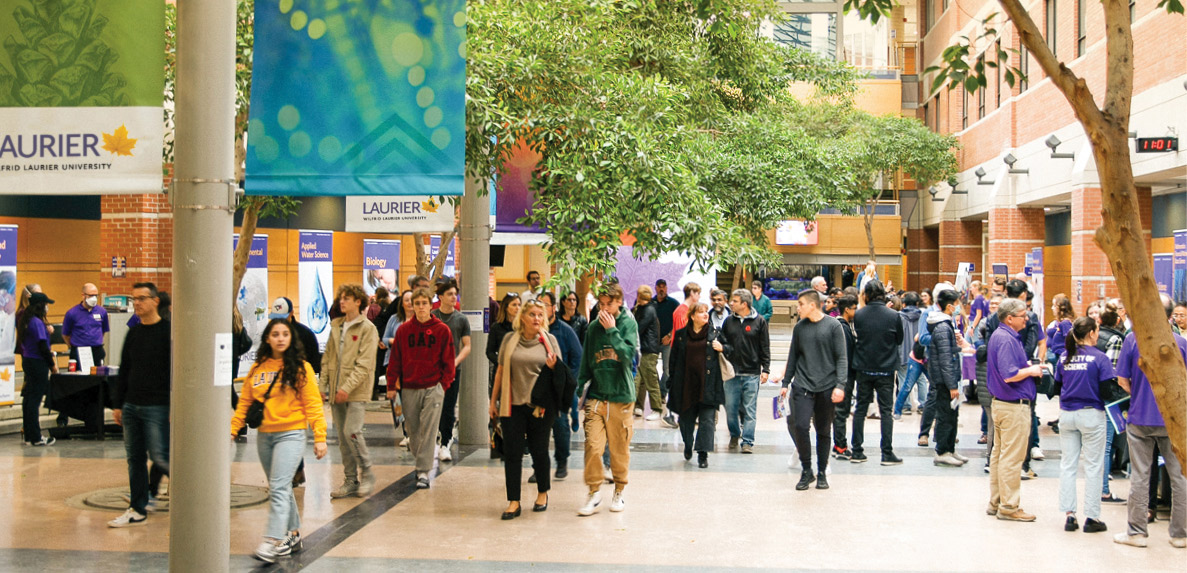 two male students walking on waterloo campus in winter