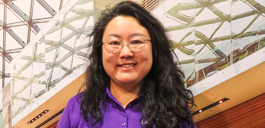 headshot of May Ma wearing purple polo-shirt