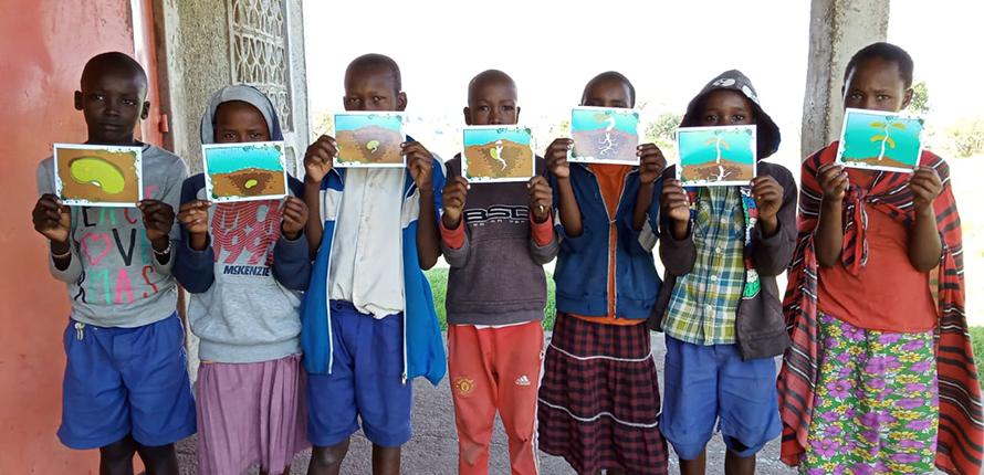 Students holding up artwork