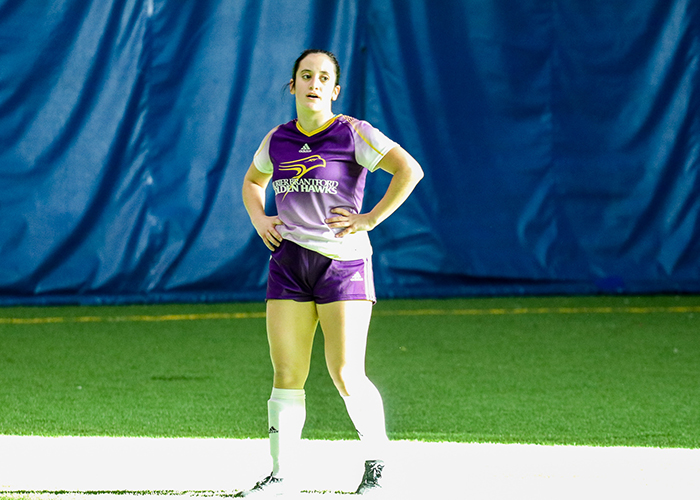 indoor soccer player standing on field